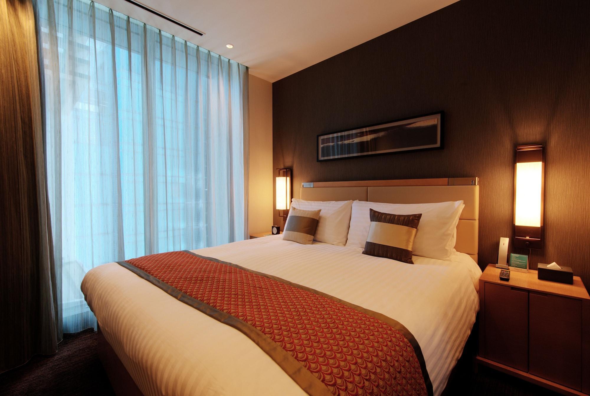 Oakwood Premier Tokyo Hotel Luaran gambar A bedroom in a hotel